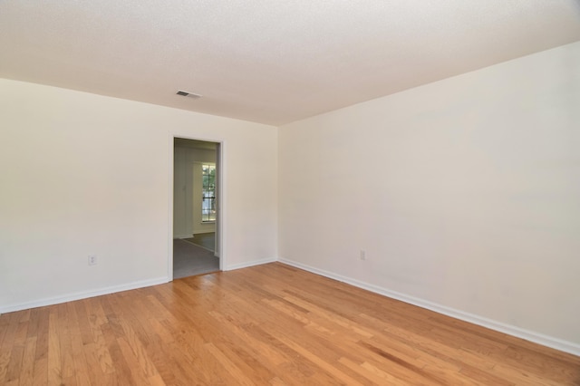 unfurnished room with light wood-type flooring