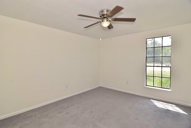 carpeted empty room featuring plenty of natural light and ceiling fan