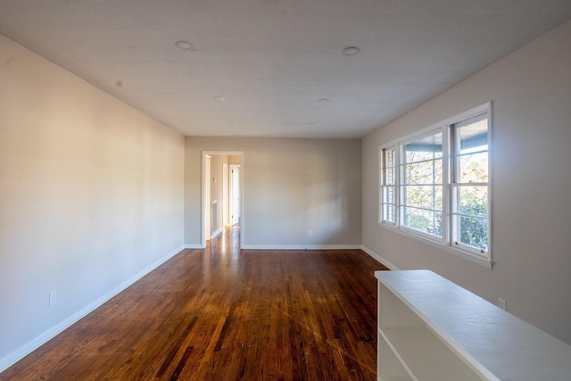 unfurnished room with dark hardwood / wood-style floors