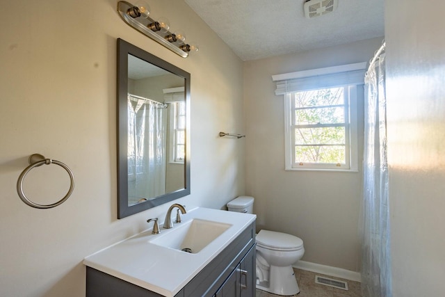 bathroom featuring toilet, tile patterned flooring, a textured ceiling, and vanity