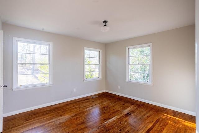 spare room with dark hardwood / wood-style flooring