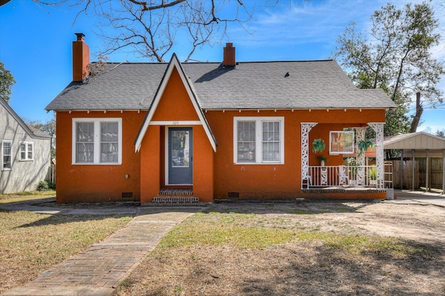 view of front of home with crawl space, covered porch, a chimney, and roof with shingles