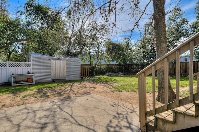 view of yard featuring an outbuilding, a storage shed, a patio area, and a fenced backyard