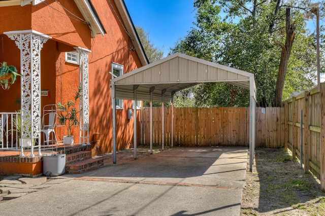 view of patio with a carport and fence