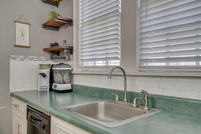 kitchen with open shelves, backsplash, white cabinetry, a sink, and dishwasher