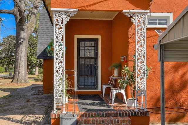 property entrance with stucco siding