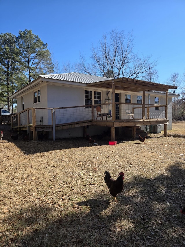 back of property featuring a deck and central air condition unit