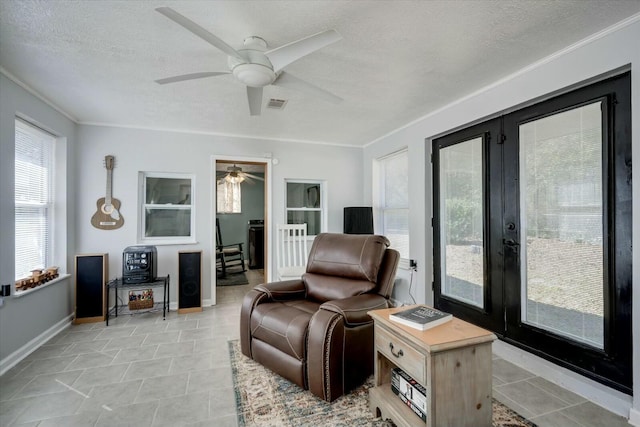 living room featuring a textured ceiling, ceiling fan, visible vents, baseboards, and french doors