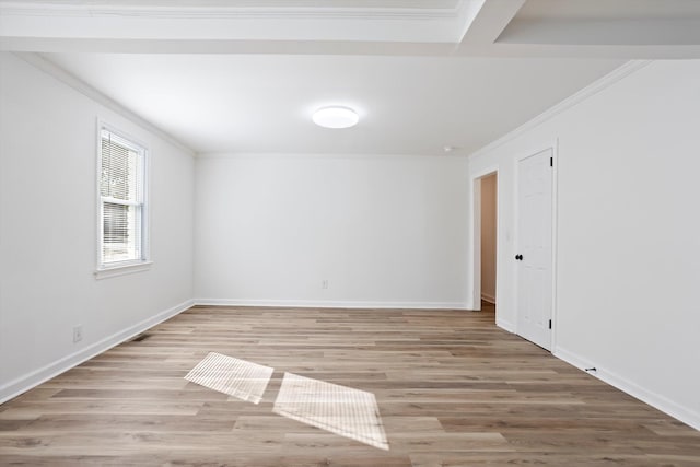 empty room with ornamental molding and light wood-type flooring