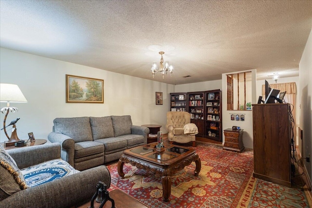 living room with a textured ceiling and a chandelier