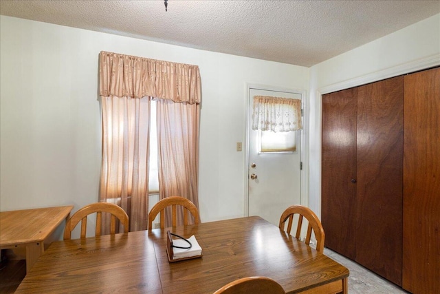 dining space with a textured ceiling