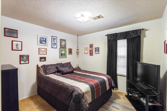 bedroom with light carpet and a textured ceiling