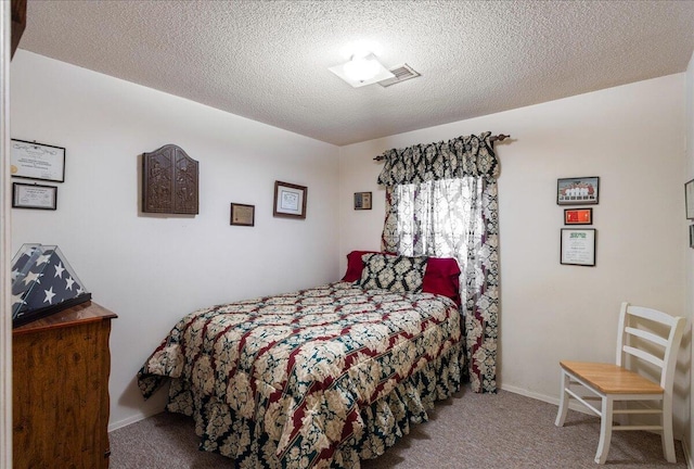 bedroom featuring carpet floors and a textured ceiling