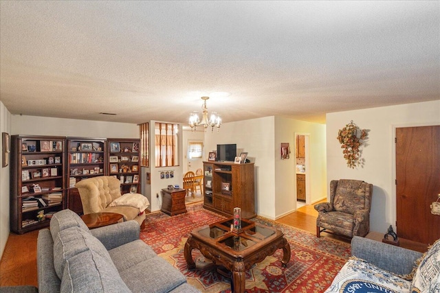 living room with a textured ceiling and a notable chandelier