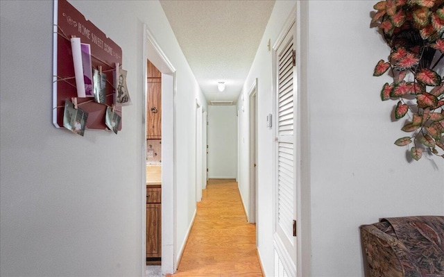 hallway with light hardwood / wood-style floors