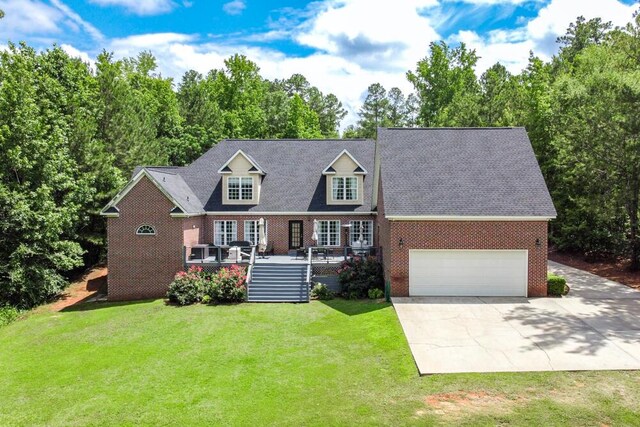 184 Deer Springs Rd, Clarks Hill, SC 29821 - cape cod home with brick siding, a front lawn, a wooden deck, and concrete driveway