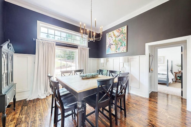 184 Deer Springs Rd, Clarks Hill, SC 29821 - dining room with a decorative wall, a chandelier, crown molding, dark wood-type flooring, and a wainscoted wall