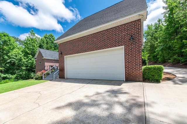 184 Deer Springs Rd, Clarks Hill, SC 29821 - view of home's exterior with brick siding, a garage, a shingled roof, and driveway