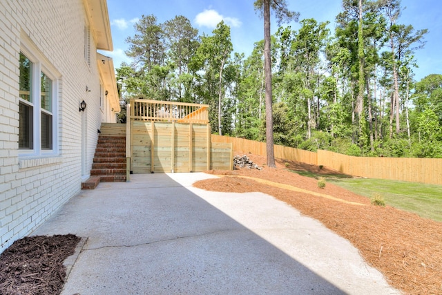 view of yard featuring a patio area, fence, stairway, and a deck
