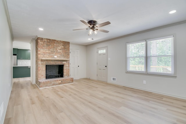 unfurnished living room featuring visible vents, a ceiling fan, light wood-style floors, and ornamental molding