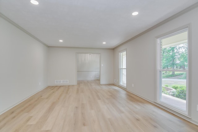 unfurnished room with visible vents, baseboards, light wood-style floors, ornamental molding, and recessed lighting