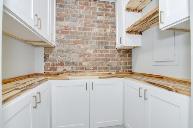 kitchen featuring white cabinets and wood counters