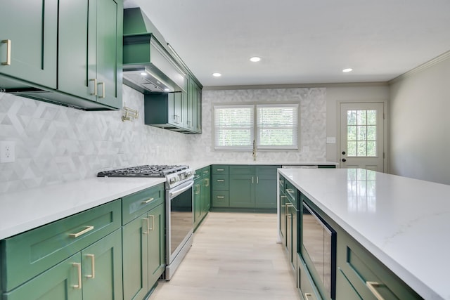 kitchen featuring custom range hood, green cabinetry, built in microwave, and gas range