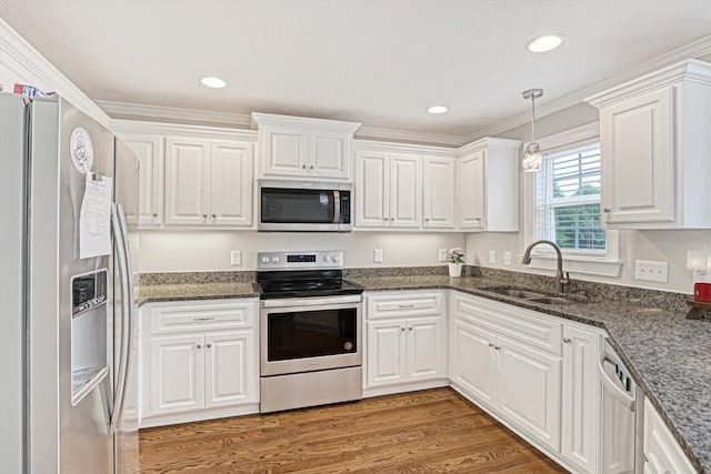 1009 Neilson St, Aiken, SC 29803 - kitchen featuring appliances with stainless steel finishes, a sink, white cabinets, light wood-style floors, and ornamental molding