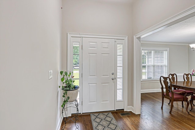 1009 Neilson St, Aiken, SC 29803 - entryway with dark wood finished floors, baseboards, plenty of natural light, crown molding, and a chandelier