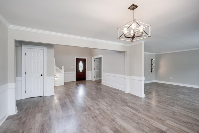 1543 Wrens Hwy, Thomson, GA 30824 - unfurnished living room with crown molding, wood finished floors, a chandelier, and stairway