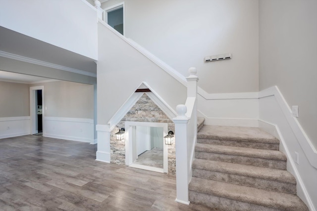 1543 Wrens Hwy, Thomson, GA 30824 - stairs with crown molding, wainscoting, and wood finished floors