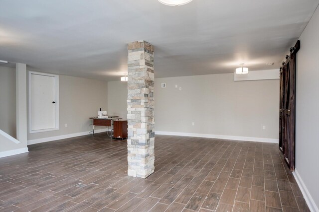 1543 Wrens Hwy, Thomson, GA 30824 - finished basement with baseboards, a barn door, and dark wood finished floors