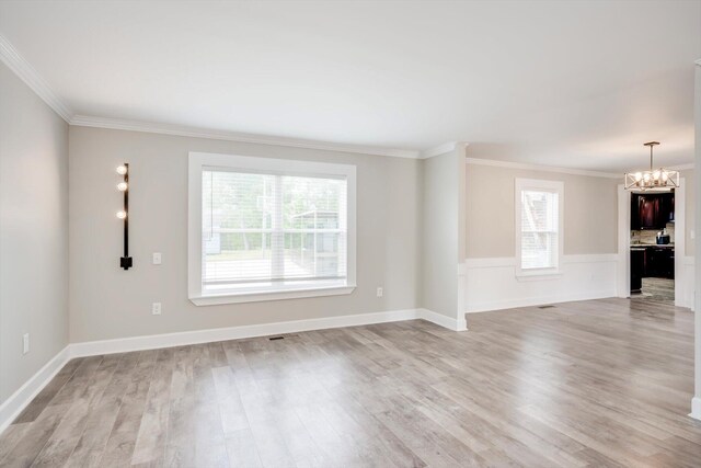 1543 Wrens Hwy, Thomson, GA 30824 - unfurnished living room featuring a chandelier, ornamental molding, visible vents, and light wood-style floors