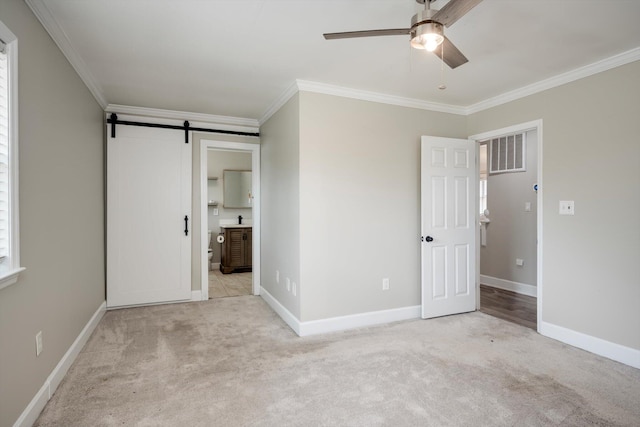 1543 Wrens Hwy, Thomson, GA 30824 - unfurnished bedroom with carpet floors, ornamental molding, and a barn door