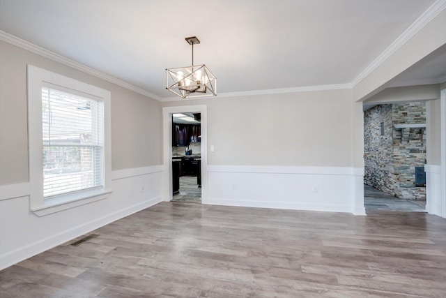 1543 Wrens Hwy, Thomson, GA 30824 - unfurnished dining area with visible vents, ornamental molding, wood finished floors, and a chandelier