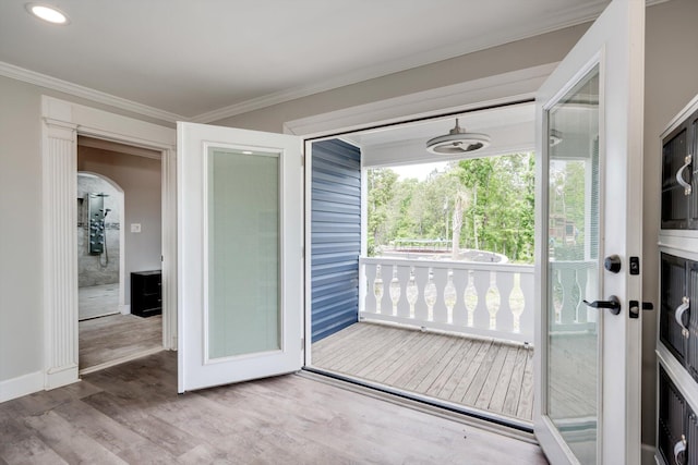 1543 Wrens Hwy, Thomson, GA 30824 - doorway to outside with crown molding, arched walkways, baseboards, and wood finished floors