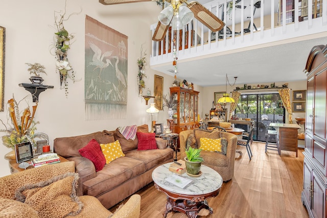 16 Cardinal Ln, North Augusta, SC 29841 - living room with light wood-style floors, ceiling fan, and a towering ceiling