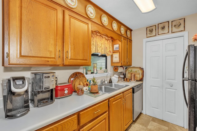 16 Cardinal Ln, North Augusta, SC 29841 - kitchen with stainless steel dishwasher, freestanding refrigerator, a sink, light countertops, and brown cabinetry