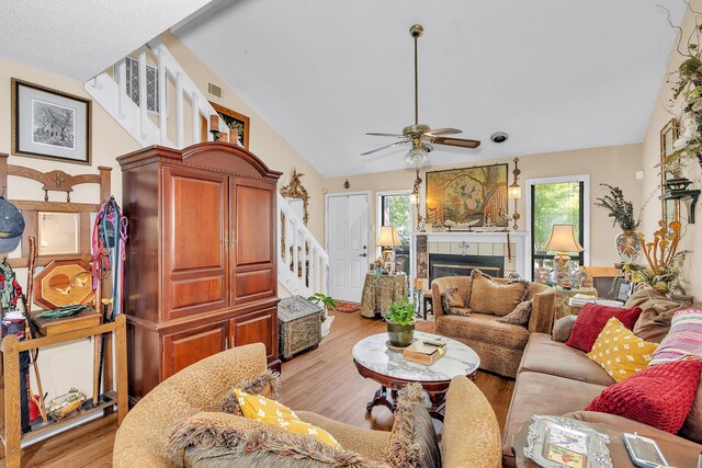 16 Cardinal Ln, North Augusta, SC 29841 - living room with vaulted ceiling, stairs, a ceiling fan, a fireplace, and light wood-style floors