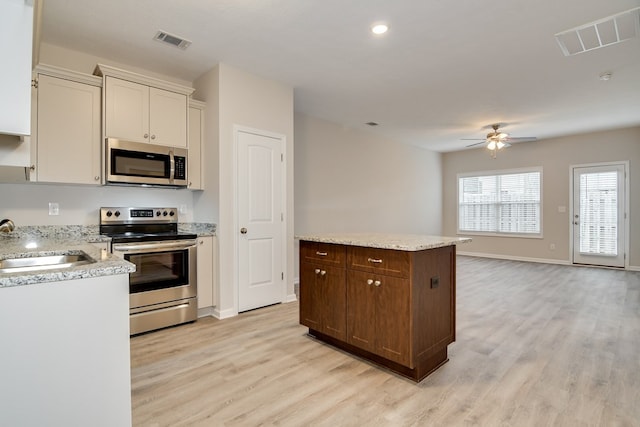 344 Bordeaux Dr, Thomson, GA 30824 - kitchen featuring stainless steel appliances, a kitchen island, sink, and light hardwood / wood-style floors