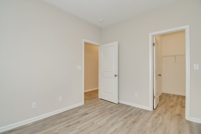 344 Bordeaux Dr, Thomson, GA 30824 - unfurnished bedroom with a spacious closet, light hardwood / wood-style floors, and a closet