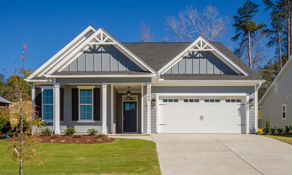 view of front of home with a front lawn and a garage