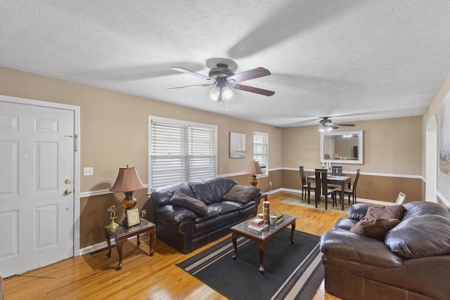 460 Archie Ware Rd, Ridge Spring, SC 29129 - living room featuring a ceiling fan, a textured ceiling, light wood-type flooring, and baseboards