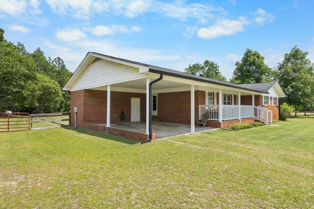 460 Archie Ware Rd, Ridge Spring, SC 29129 - view of side of home featuring brick siding, an attached carport, and covered porch