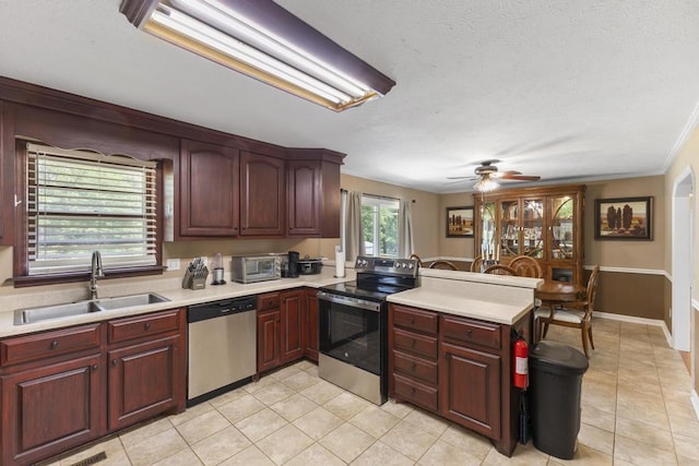 460 Archie Ware Rd, Ridge Spring, SC 29129 - kitchen with stainless steel appliances, a sink, a peninsula, light countertops, and light tile patterned floors