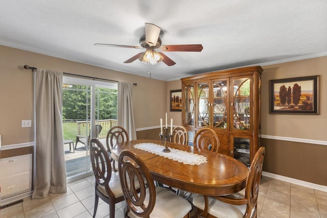 460 Archie Ware Rd, Ridge Spring, SC 29129 - dining room with a ceiling fan, light tile patterned flooring, a textured ceiling, baseboards, and crown molding