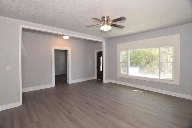 empty room featuring a textured ceiling, dark hardwood / wood-style floors, and ceiling fan