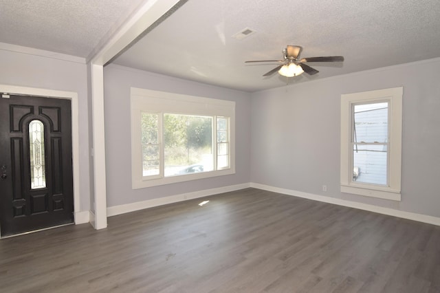 entryway with ceiling fan, beamed ceiling, dark hardwood / wood-style floors, and a textured ceiling