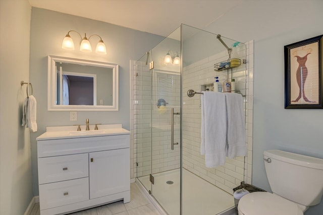 bathroom featuring a shower stall, toilet, and vanity