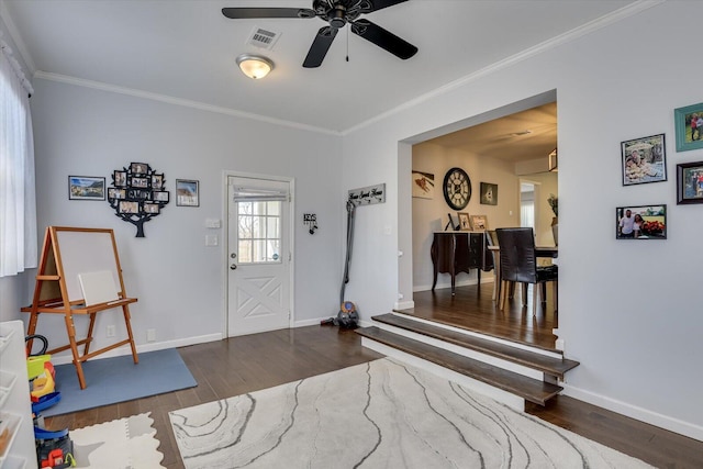 entryway featuring ornamental molding, visible vents, baseboards, and wood finished floors